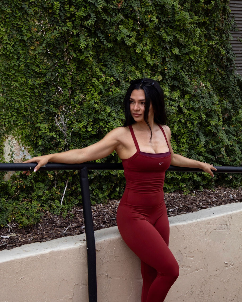DUAL Garnet top and leggings against an ivy wall