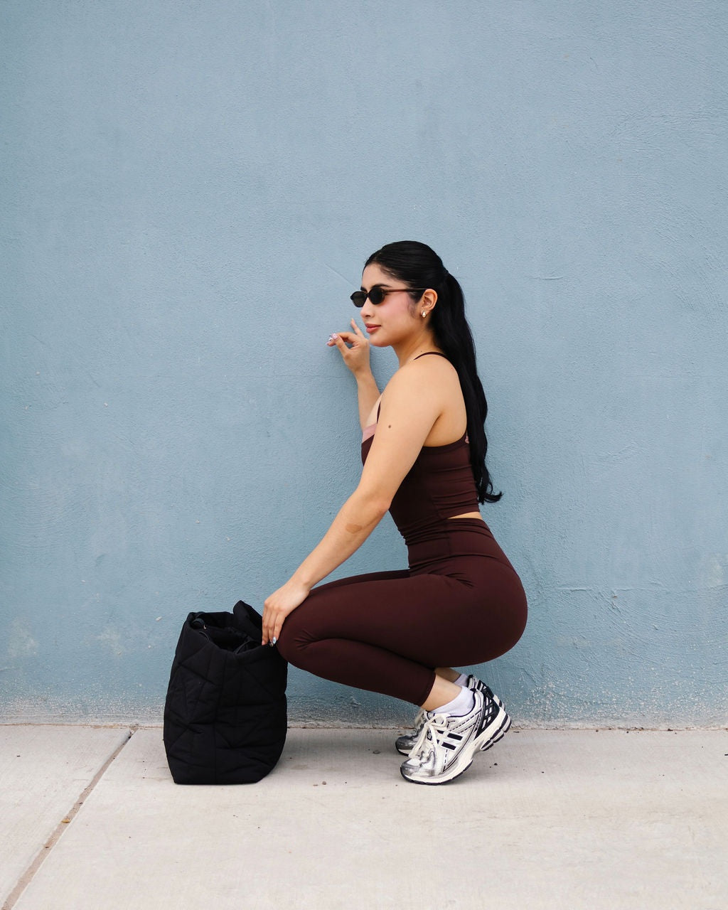 DUAL Sienna top and leggings against a blue wall